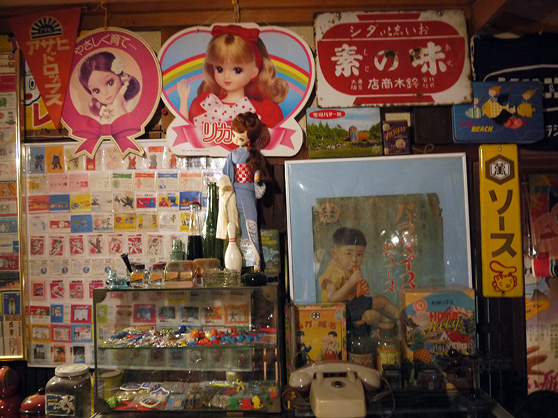 A couple of signs with a doll of Licca-chan