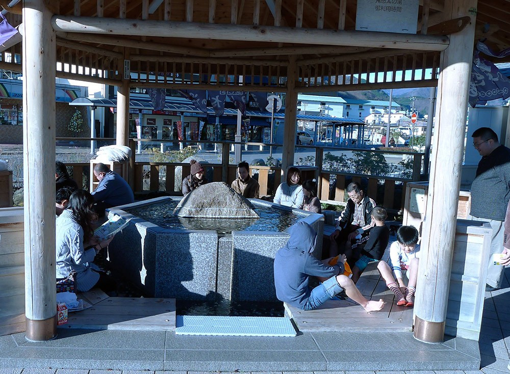 people at a foot onsen in japan