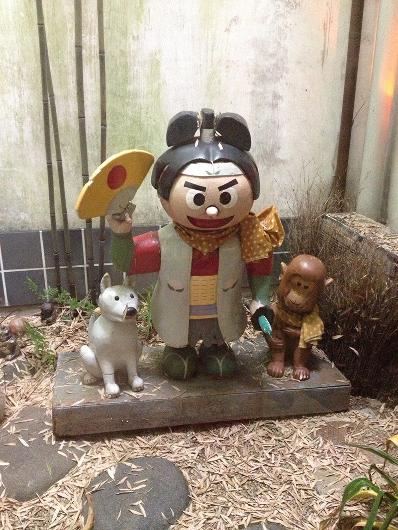 Momotaro statue with dog and monkey friend