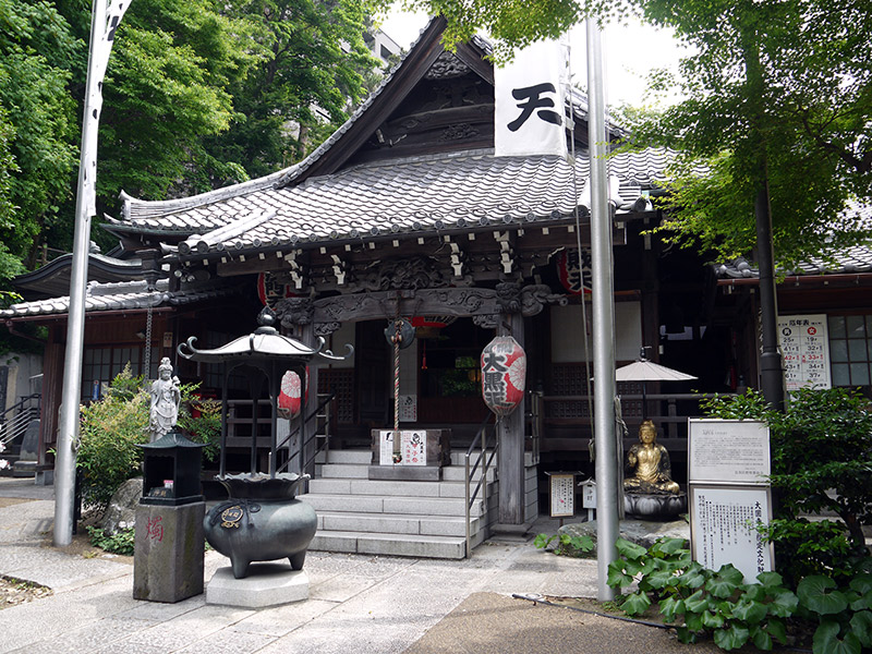 japanese shrine outside flags and trees