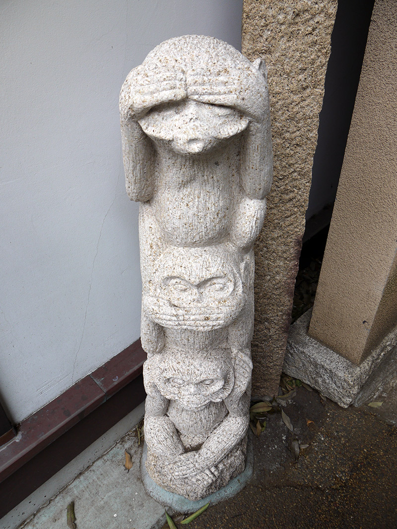 japanese shrine stone statue see no evil monkey