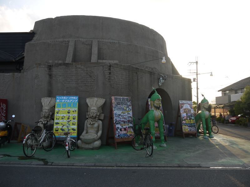 sphinx and alien statues outside a building not egypt