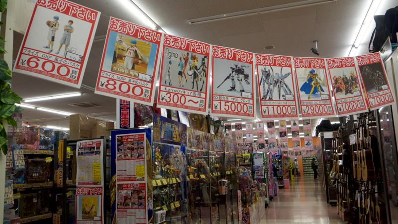 signs advertising japanese toys cartoons manga in a store