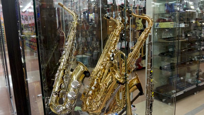 three shiny saxophones for sale