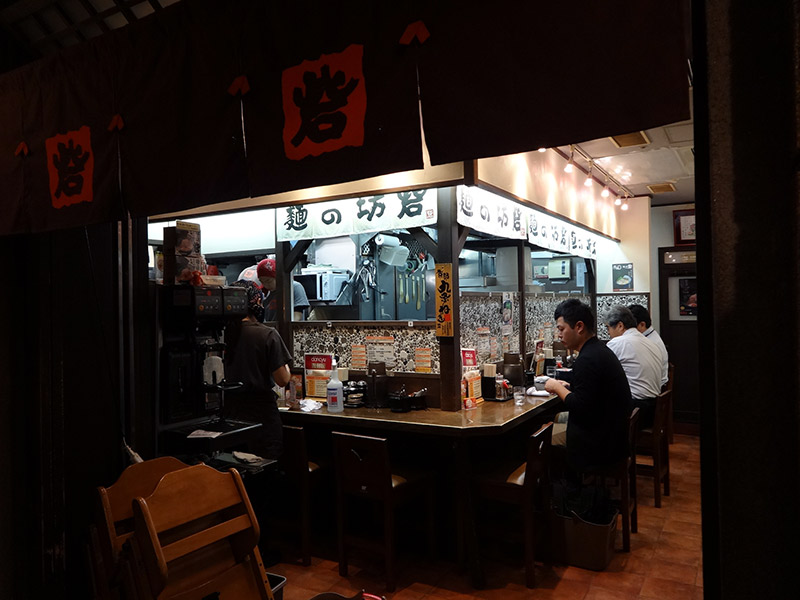 Japanese sitting at ramen bar