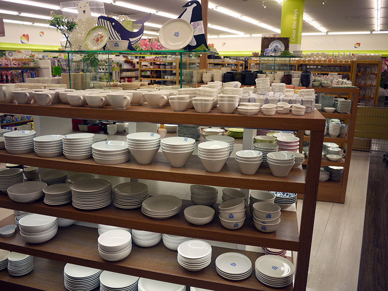 Cream-colored dishes stacked up on shelves