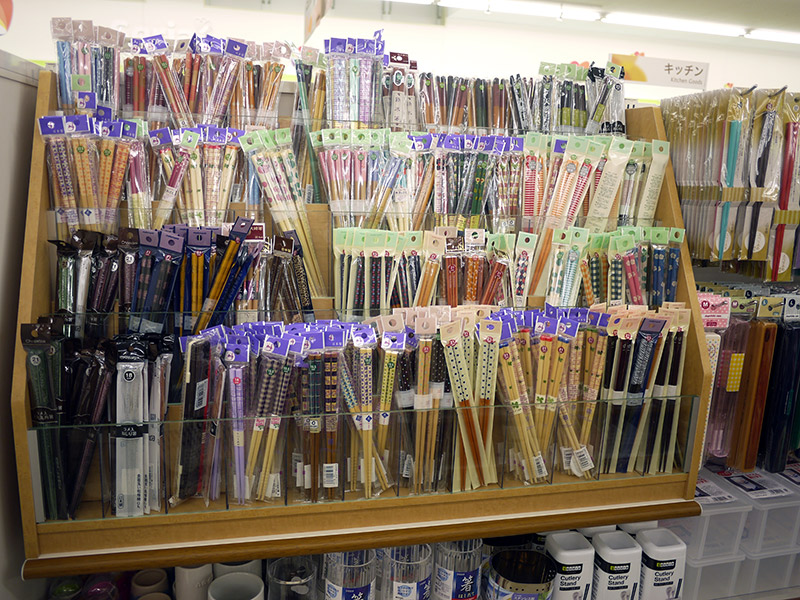 Plain and patterned wooden chopsticks in plastic packaging