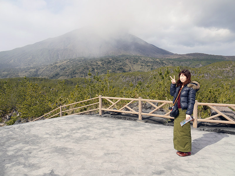 Woman posing in front of volcano