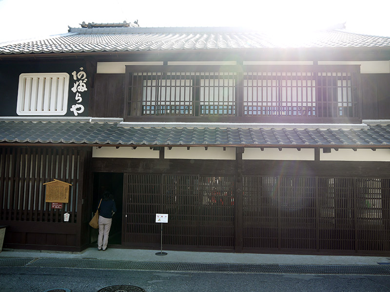 sunny image outside of inn with person walking in