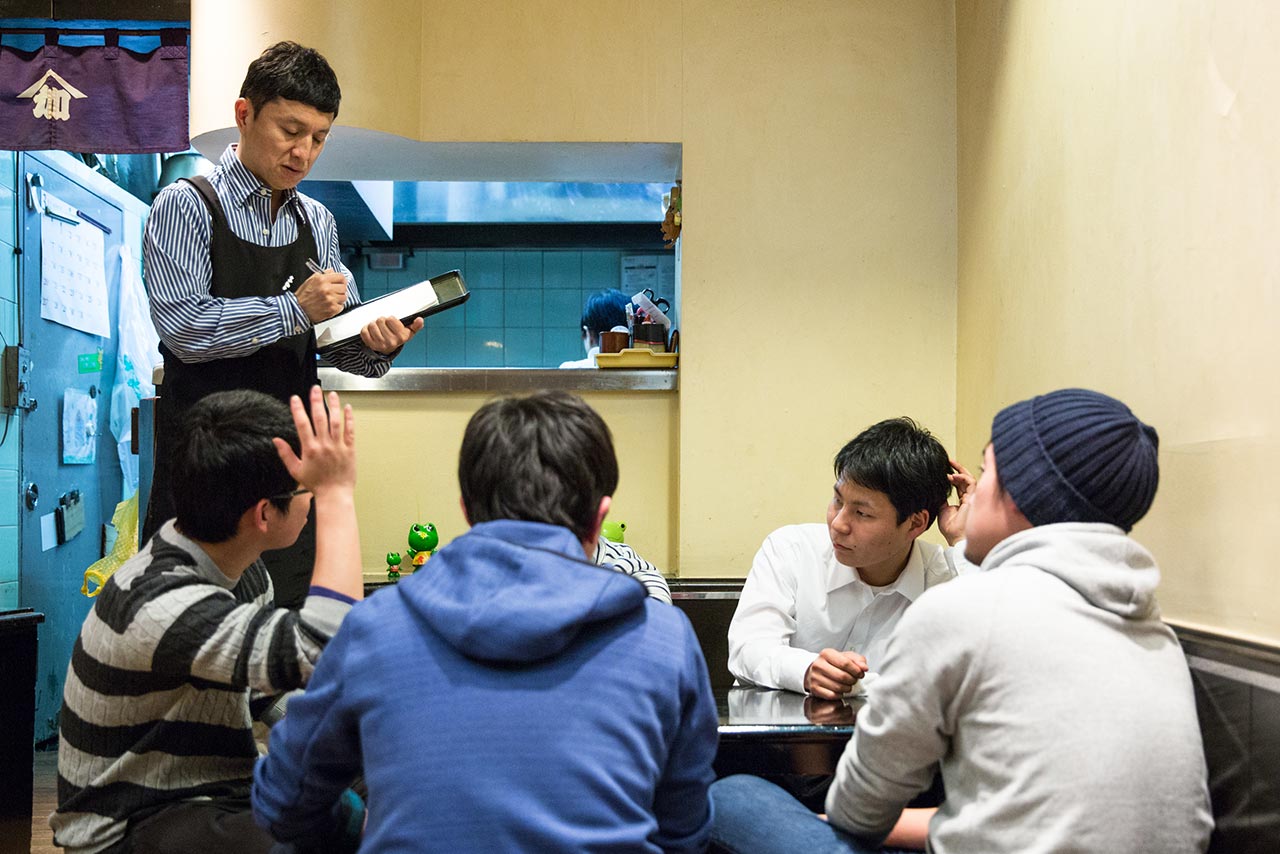 Kagaya taking an order from a nearby table