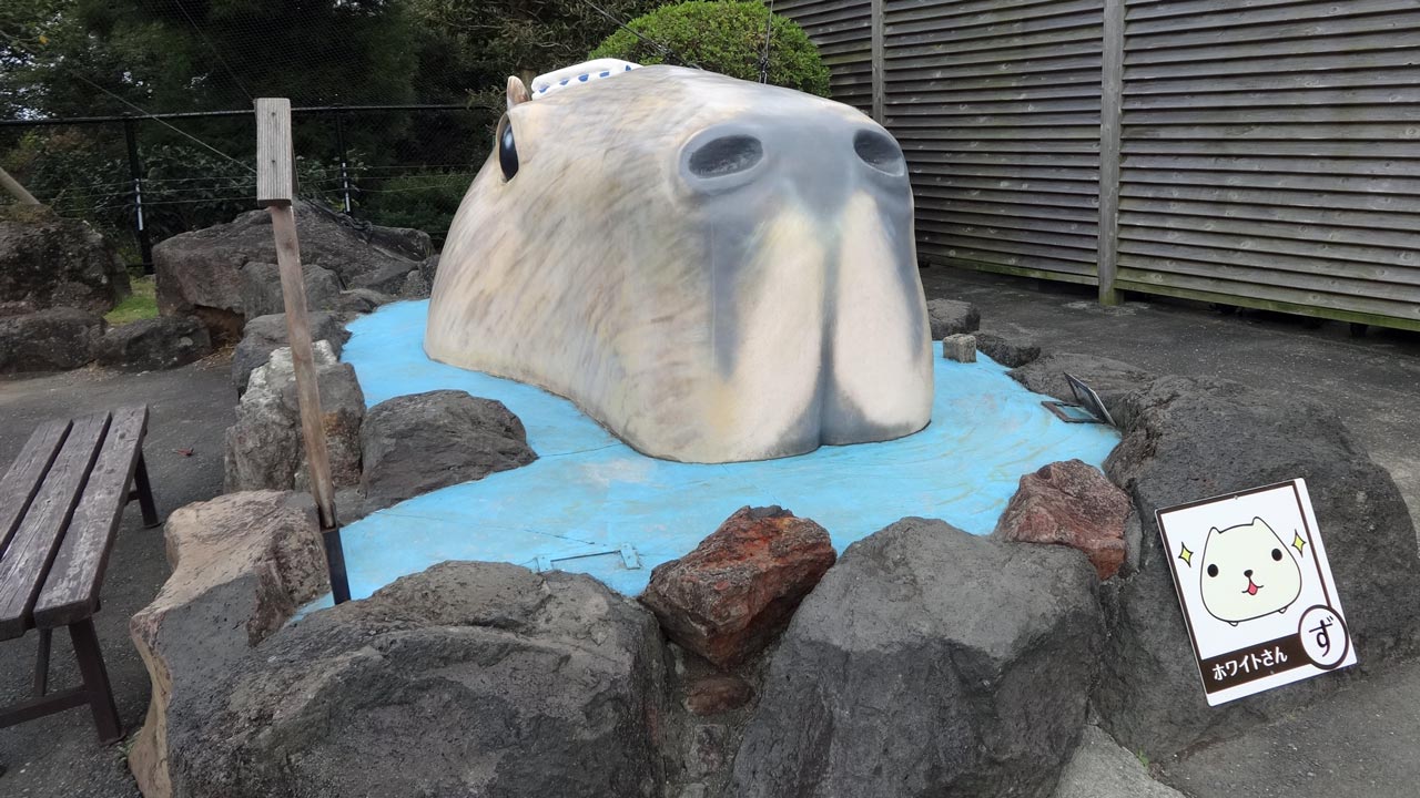 giant statue of a capybara in a hot spring