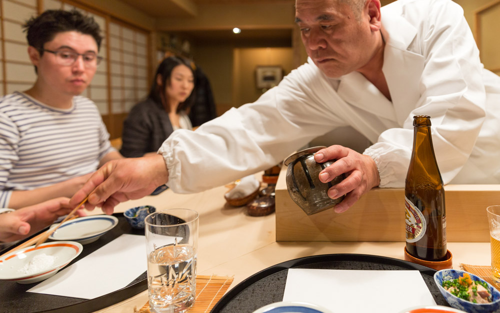 chef sakakibara pouring salt