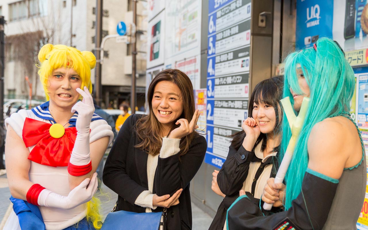 two men in cosplay posing in akihabara