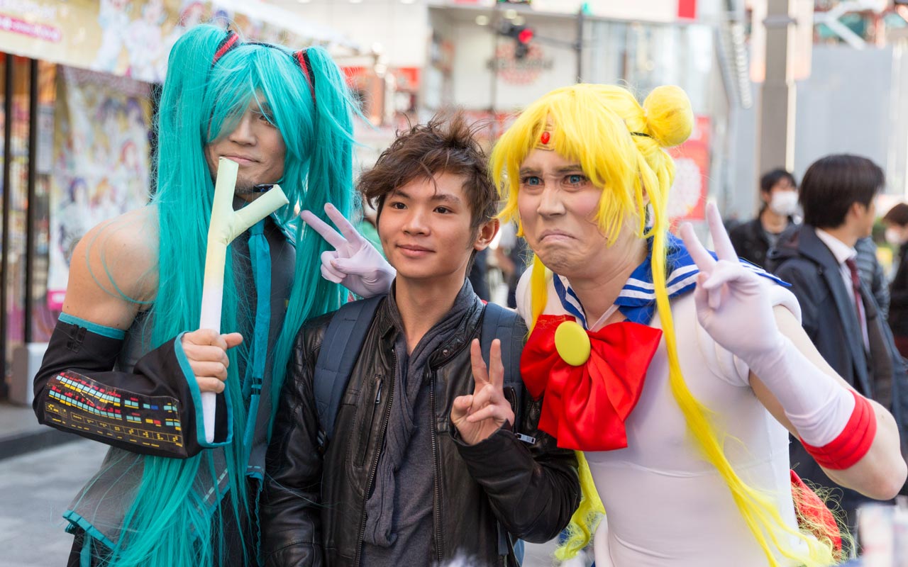 two men in cosplay posing with man on the street