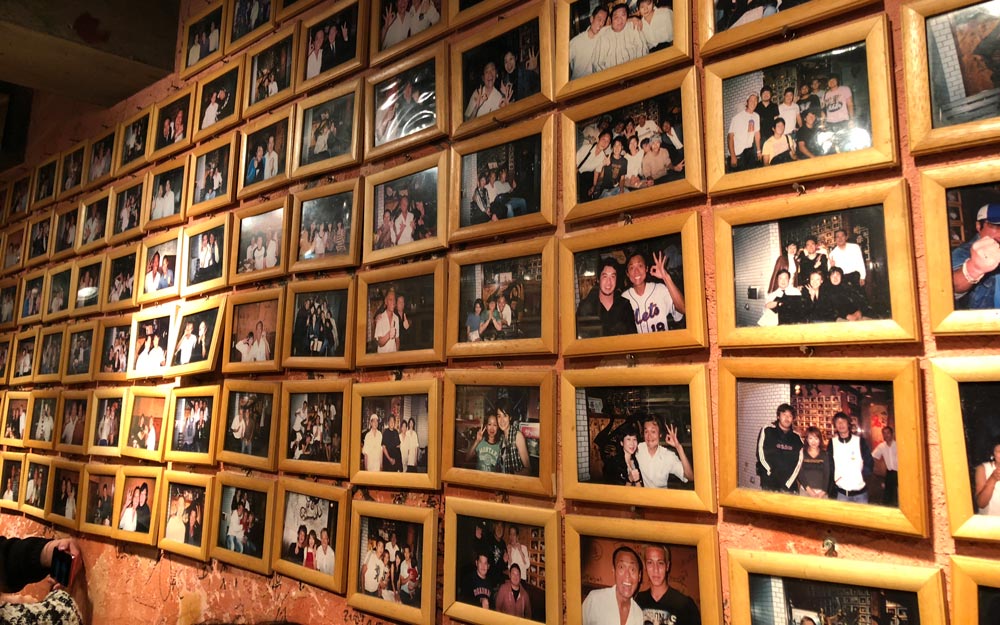 wall of celebrity photos at yakiniku meimon in shinjuku