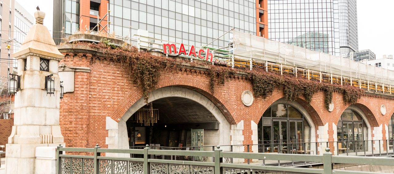 old japanese train station with light up sign reading maach ecute