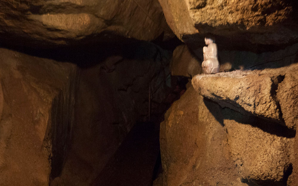 small statue between rocks