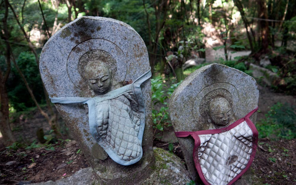 old jizo statues with bibs