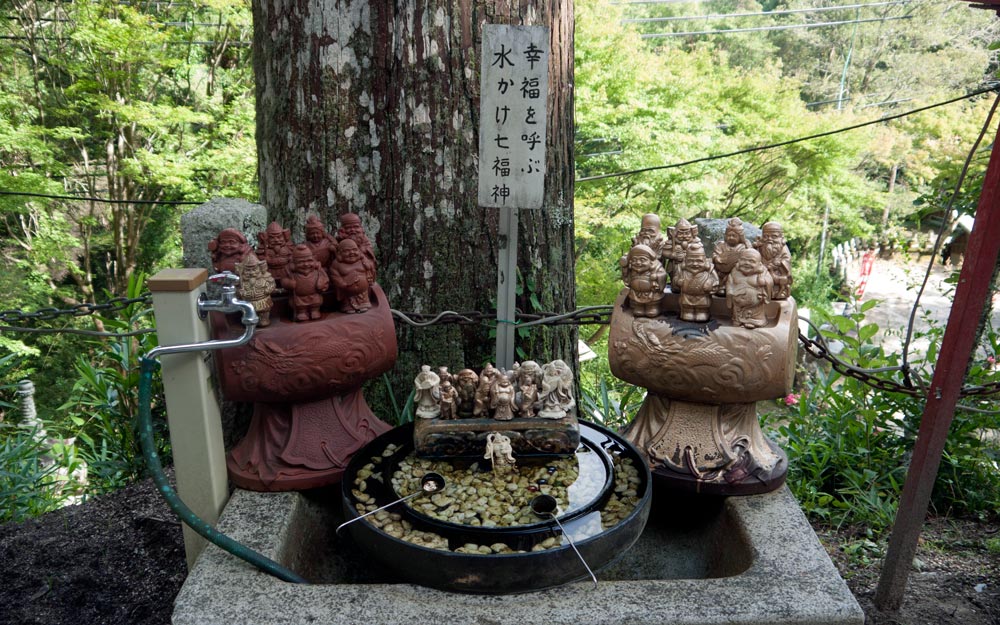 statues of seven lucky gods at water basin