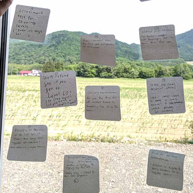 sticky notes on the window from brainstorming sessions