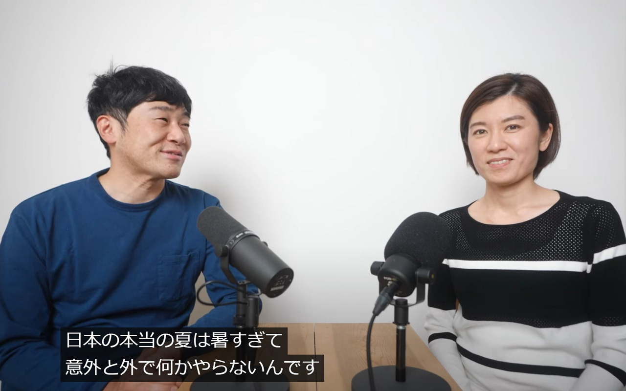 photo of two people sitting across a table in front of mics